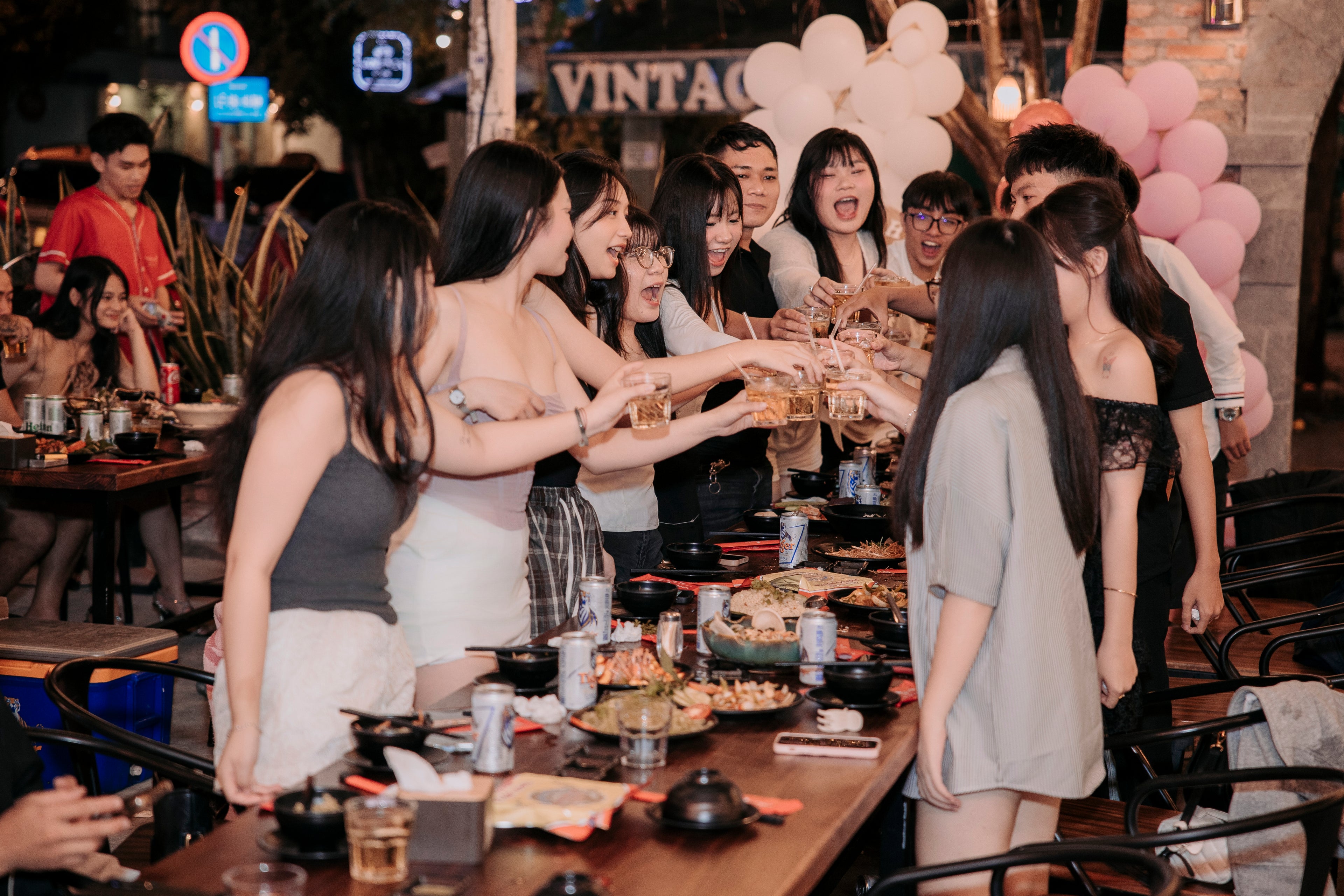 a group of friends eating and drinking at Lantern Garden