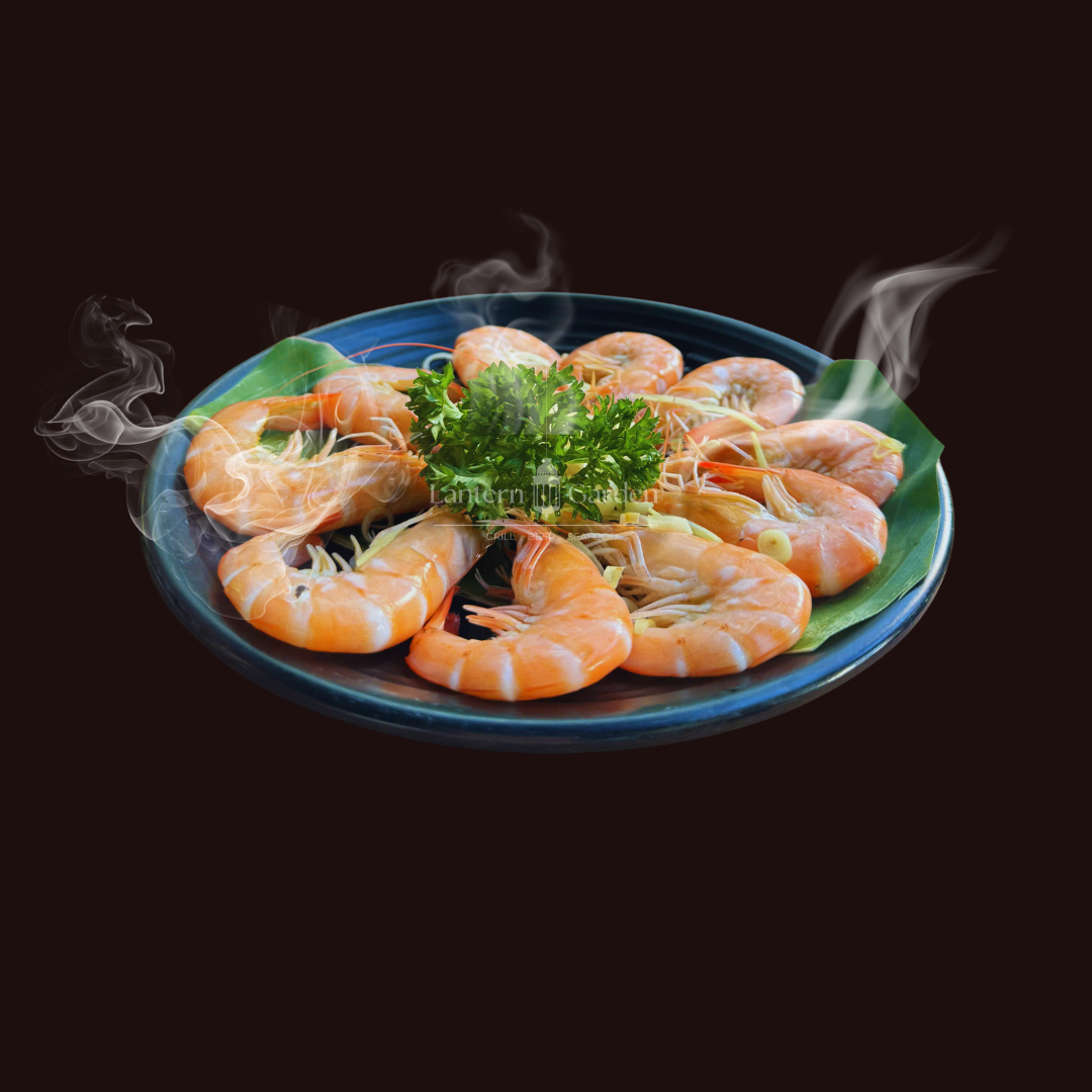 Steaming shrimp dish on a blue plate with steam rising, against a black background